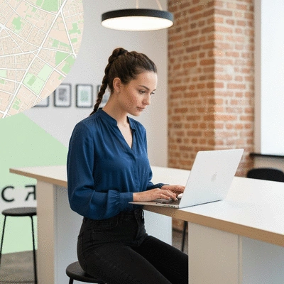 Professional webmaster working on a laptop with Avignon city map in background